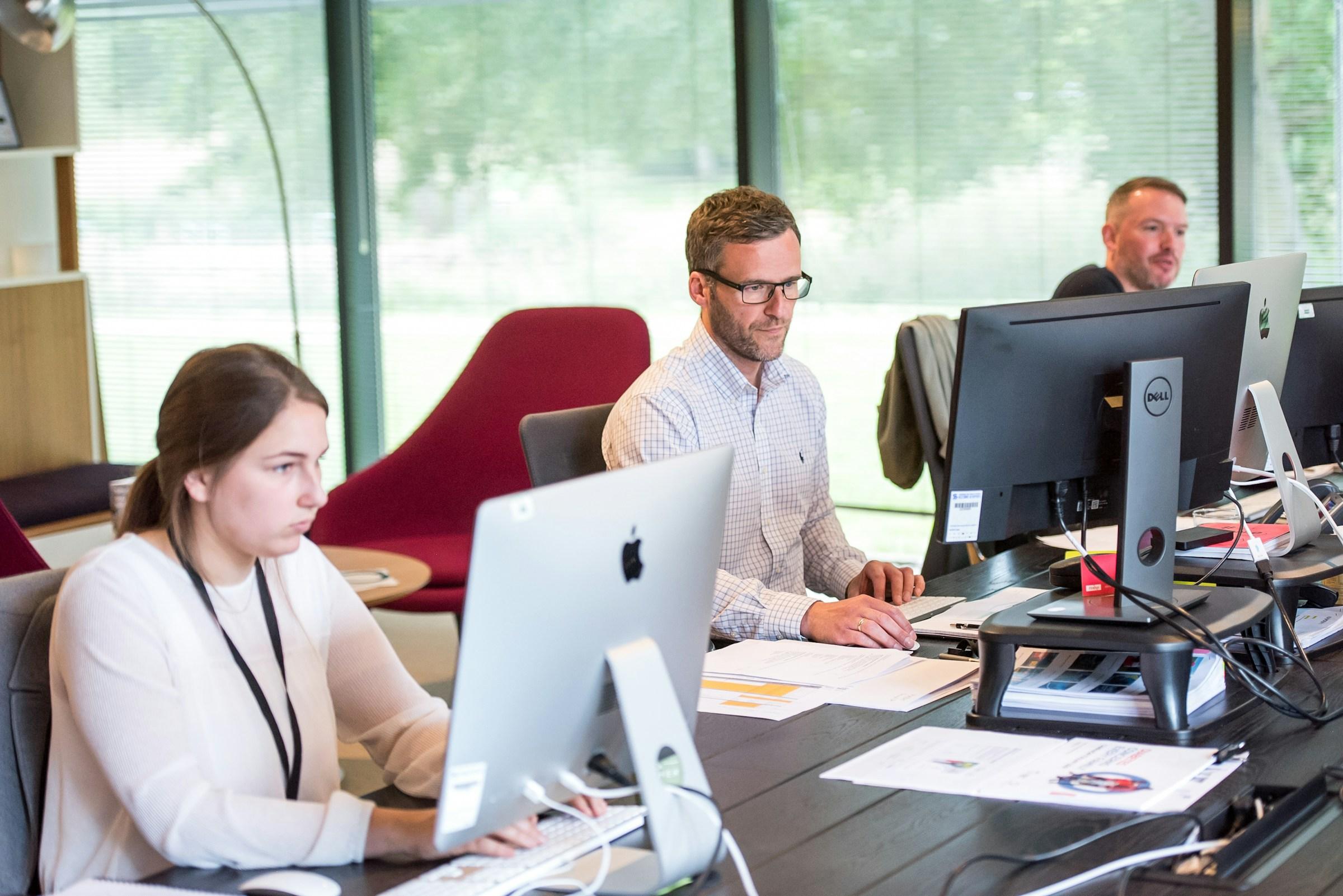 Customer service team working at their desks in an open-plan office